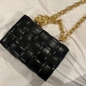 Black purse with gold hardware in perfect condition